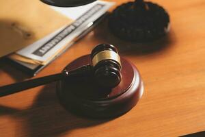 Business and lawyers discussing contract papers with brass scale on desk in office. Law, legal services, advice, justice and law concept picture with film grain effect photo