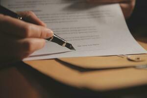 Business and lawyers discussing contract papers with brass scale on desk in office. Law, legal services, advice, justice and law concept picture with film grain effect photo