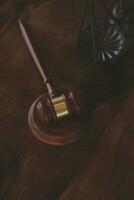 Justice and law concept.Male judge in a courtroom with the gavel, working with, computer and docking keyboard, eyeglasses, on table in morning light photo