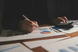 Close up businessman hand using calculator and working with laptop calculate about finance accounting at coffeeshop outdor.finance accounting concept photo