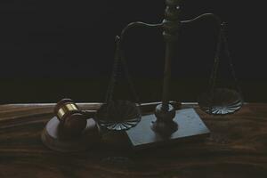 Justice and law concept.Male judge in a courtroom with the gavel, working with, computer and docking keyboard, eyeglasses, on table in morning light photo