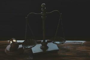 Justice and law concept.Male judge in a courtroom with the gavel, working with, computer and docking keyboard, eyeglasses, on table in morning light photo