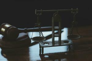 Justice and law concept.Male judge in a courtroom with the gavel, working with, computer and docking keyboard, eyeglasses, on table in morning light photo