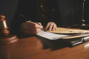 Business and lawyers discussing contract papers with brass scale on desk in office. Law, legal services, advice, justice and law concept picture with film grain effect photo