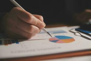 Close up businessman hand using calculator and working with laptop calculate about finance accounting at coffeeshop outdor.finance accounting concept photo