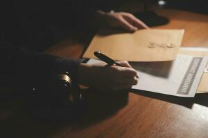 Business and lawyers discussing contract papers with brass scale on desk in office. Law, legal services, advice, justice and law concept picture with film grain effect photo