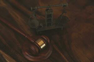 Justice and law concept.Male judge in a courtroom with the gavel, working with, computer and docking keyboard, eyeglasses, on table in morning light photo