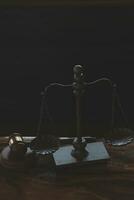 Justice and law concept.Male judge in a courtroom with the gavel, working with, computer and docking keyboard, eyeglasses, on table in morning light photo