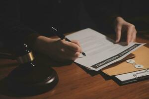 Business and lawyers discussing contract papers with brass scale on desk in office. Law, legal services, advice, justice and law concept picture with film grain effect photo