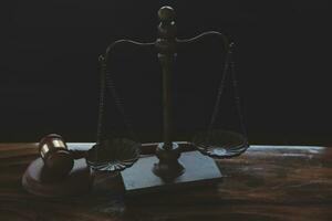 Justice and law concept.Male judge in a courtroom with the gavel, working with, computer and docking keyboard, eyeglasses, on table in morning light photo