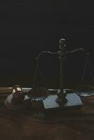 Justice and law concept.Male judge in a courtroom with the gavel, working with, computer and docking keyboard, eyeglasses, on table in morning light photo