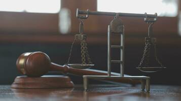 Justice and law concept.Male judge in a courtroom with the gavel, working with, computer and docking keyboard, eyeglasses, on table in morning light photo