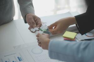 Cropped shot of Businesswoman hand connecting jigsaw puzzle with sunlight effect, Business solutions, success, and Assembling jigsaw pieces, strategy ideas. photo