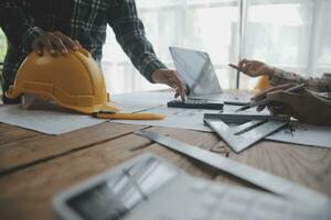 Construction and structure concept of engineer working drawing on blueprint meeting for project working with partner on model building and engineering tools in working site, construction concept. photo