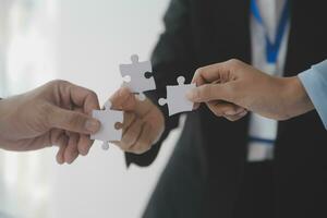 Cropped shot of Businesswoman hand connecting jigsaw puzzle with sunlight effect, Business solutions, success, and Assembling jigsaw pieces, strategy ideas. photo