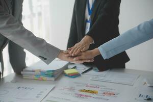 A group of businesspeople and investors meet to discuss market's success in past quarter. idea of setting up a marketing consulting team and working together as a team made it a success. photo
