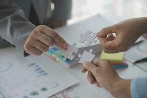 Cropped shot of Businesswoman hand connecting jigsaw puzzle with sunlight effect, Business solutions, success, and Assembling jigsaw pieces, strategy ideas. photo