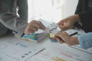 Cropped shot of Businesswoman hand connecting jigsaw puzzle with sunlight effect, Business solutions, success, and Assembling jigsaw pieces, strategy ideas. photo