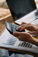 Business Man Financial Inspector and Secretary Making Report, Calculating or Checking Balance. Internal Revenue Service Inspector Checking Document Audit Concept photo