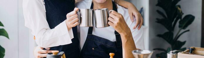 Happy young adult couple making breakfast and drinking coffee together in cozy home kitchen in morning at home. Preparing meal and smiling. Lifestyle, leisure and Love concept. photo