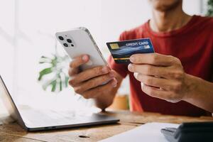 Businesswoman hands holding cradit card and using credit card online shopping. Online shopping concept photo