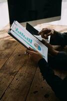 Financial Business woman analyze the graph of the company's performance to create profits and growth, Market research reports and income statistics, data,repotr,Financial and Accounting concept. photo