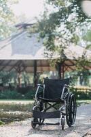 Asian young woman nurse at nursing home take care disabled senior man. Caregiver doctor serve physical therapy for older elderly patient to exercise and practice walking on walker or cane at backyard. photo