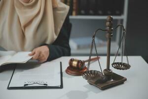 Business and lawyers discussing contract papers with brass scale on desk in office. Law, legal services, advice, justice and law concept picture with film grain effect photo