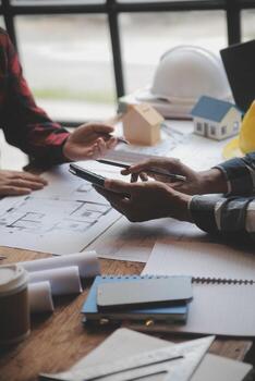 Engineer Teamwork Meeting, Drawing working on blueprint meeting for project working with partner on model building and engineering tools in working site, Construction and structure concept. photo