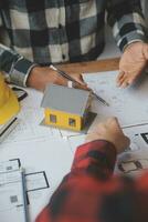 Engineer Teamwork Meeting, Drawing working on blueprint meeting for project working with partner on model building and engineering tools in working site, Construction and structure concept. photo