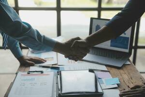 Business success. Businesspeople shake hands to confirm agreements to do business together and invest in companies to collect capital to expand new companies. photo