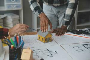 Engineer Teamwork Meeting, Drawing working on blueprint meeting for project working with partner on model building and engineering tools in working site, Construction and structure concept. photo