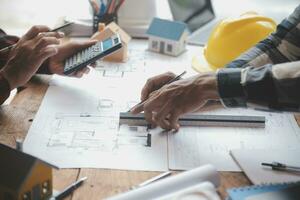 Engineer Teamwork Meeting, Drawing working on blueprint meeting for project working with partner on model building and engineering tools in working site, Construction and structure concept. photo