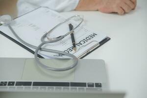 Health care billing statement with stethoscope, bottle of medicine for doctor's work in medical center stone background. photo