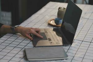 Cropped photo of Freelancer business Asian woman holding coffee cup and at doing planning analyzing the financial report, business plan investment, finance analysis the workplace.