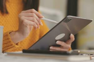 Cropped photo of Freelancer business Asian woman holding coffee cup and at doing planning analyzing the financial report, business plan investment, finance analysis the workplace.