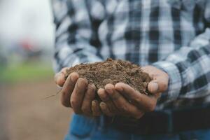 Symbol heart earth day. Handful of dirt hands heart shape. Farm organic earth. Farmer hands soil ground earth dirt garden soil farm ground. Male hands full of fertile land field agriculture concept photo