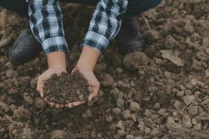 Symbol heart earth day. Handful of dirt hands heart shape. Farm organic earth. Farmer hands soil ground earth dirt garden soil farm ground. Male hands full of fertile land field agriculture concept photo