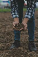 Symbol heart earth day. Handful of dirt hands heart shape. Farm organic earth. Farmer hands soil ground earth dirt garden soil farm ground. Male hands full of fertile land field agriculture concept photo