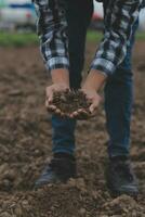 Symbol heart earth day. Handful of dirt hands heart shape. Farm organic earth. Farmer hands soil ground earth dirt garden soil farm ground. Male hands full of fertile land field agriculture concept photo