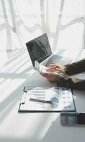 Financial Business woman analyze the graph of the company's performance to create profits and growth, Market research reports and income statistics, data,repotr,Financial and Accounting concept. photo