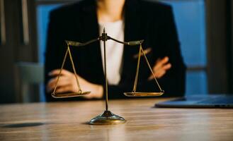 Justice and law concept.Male judge in a courtroom with the gavel, working with, computer and docking keyboard, eyeglasses, on table in morning light photo