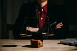 Justice and law concept.Male judge in a courtroom with the gavel, working with, computer and docking keyboard, eyeglasses, on table in morning light photo