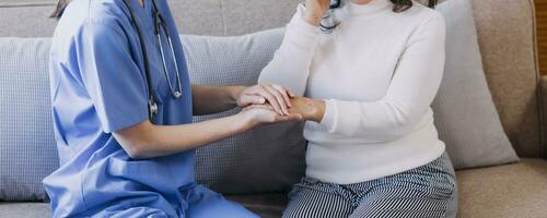 Homecare nursing service and elderly people cardiology healthcare. Close up of young hispanic female doctor nurse check mature caucasian man patient heartbeat using stethoscope during visit photo