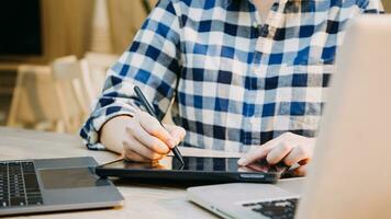 Shot of a asian young business Female working on laptop in her workstation. photo