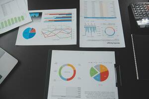 Financial analysts analyze business financial reports on a digital tablet planning investment project during a discussion at a meeting of corporate showing the results of their successful teamwork. photo