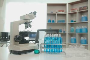 Health care researchers working in life science laboratory. Young female research scientist and senior male supervisor preparing and analyzing microscope slides in research lab. photo