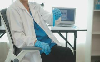 Health care researchers working in life science laboratory. Young female research scientist and senior male supervisor preparing and analyzing microscope slides in research lab. photo