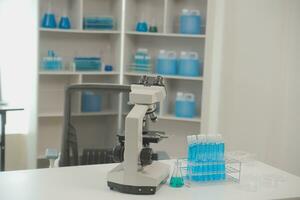 Health care researchers working in life science laboratory. Young female research scientist and senior male supervisor preparing and analyzing microscope slides in research lab. photo