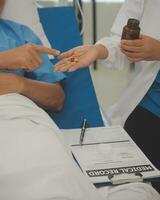 Close up of Female Doctor using stethoscope putting beat heart diagnose with patient in examination room at a hospital, check-up body, Medical and Health Care Concept. photo